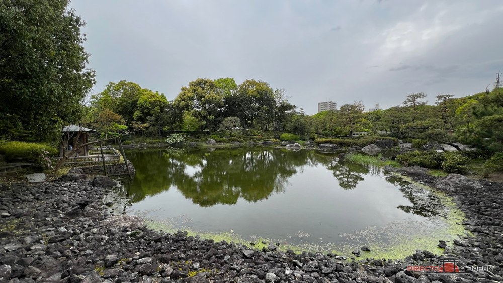Orilla de un estanque cubierta de rocas colocadas una a una, en el jardín Shirotori de Nagoya.